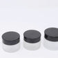 Clear frosted glass jar with black cap